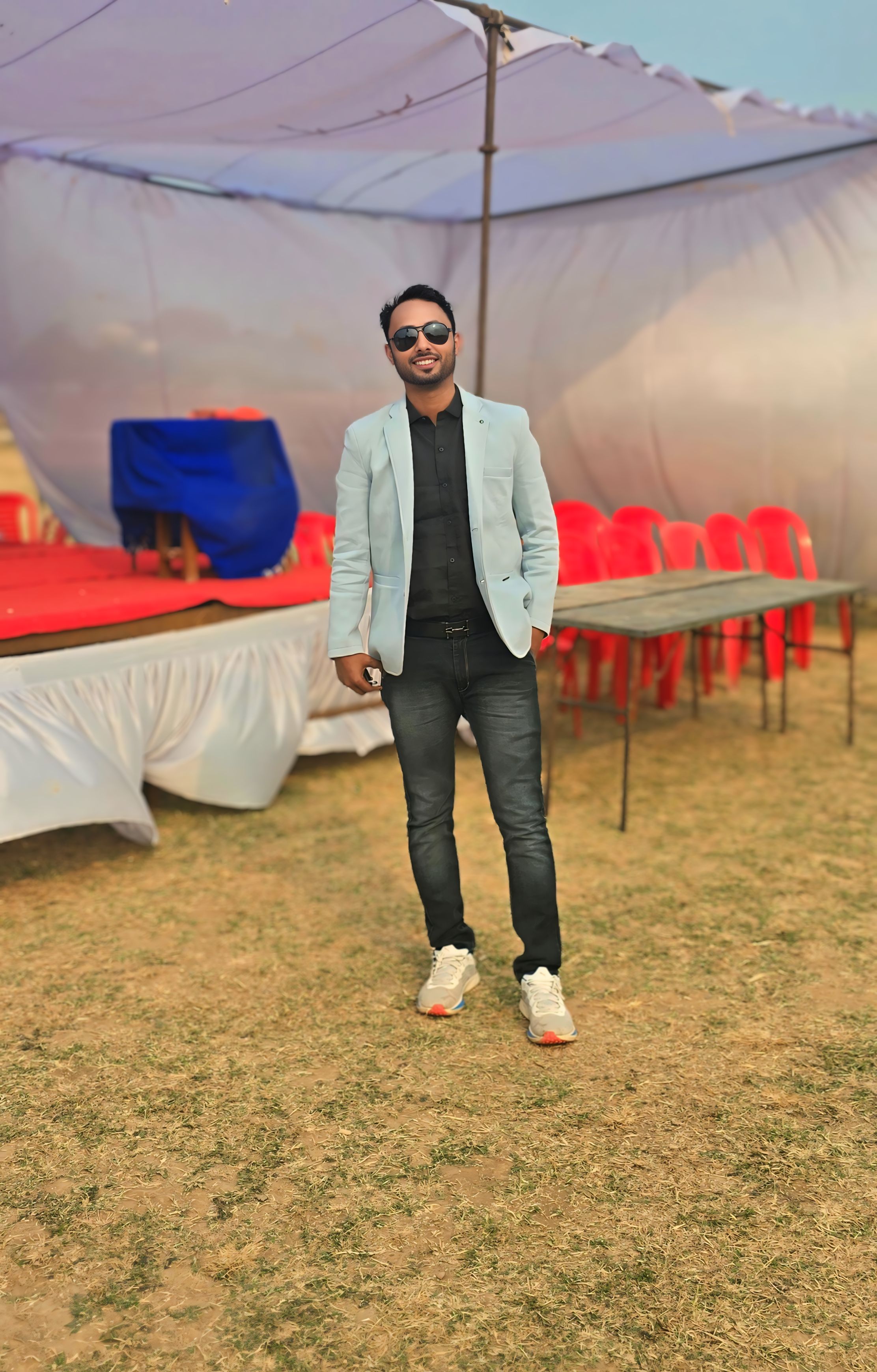 Professional portrait on outdoor event ground wearing light blue blazer - Sports event coordination appearance