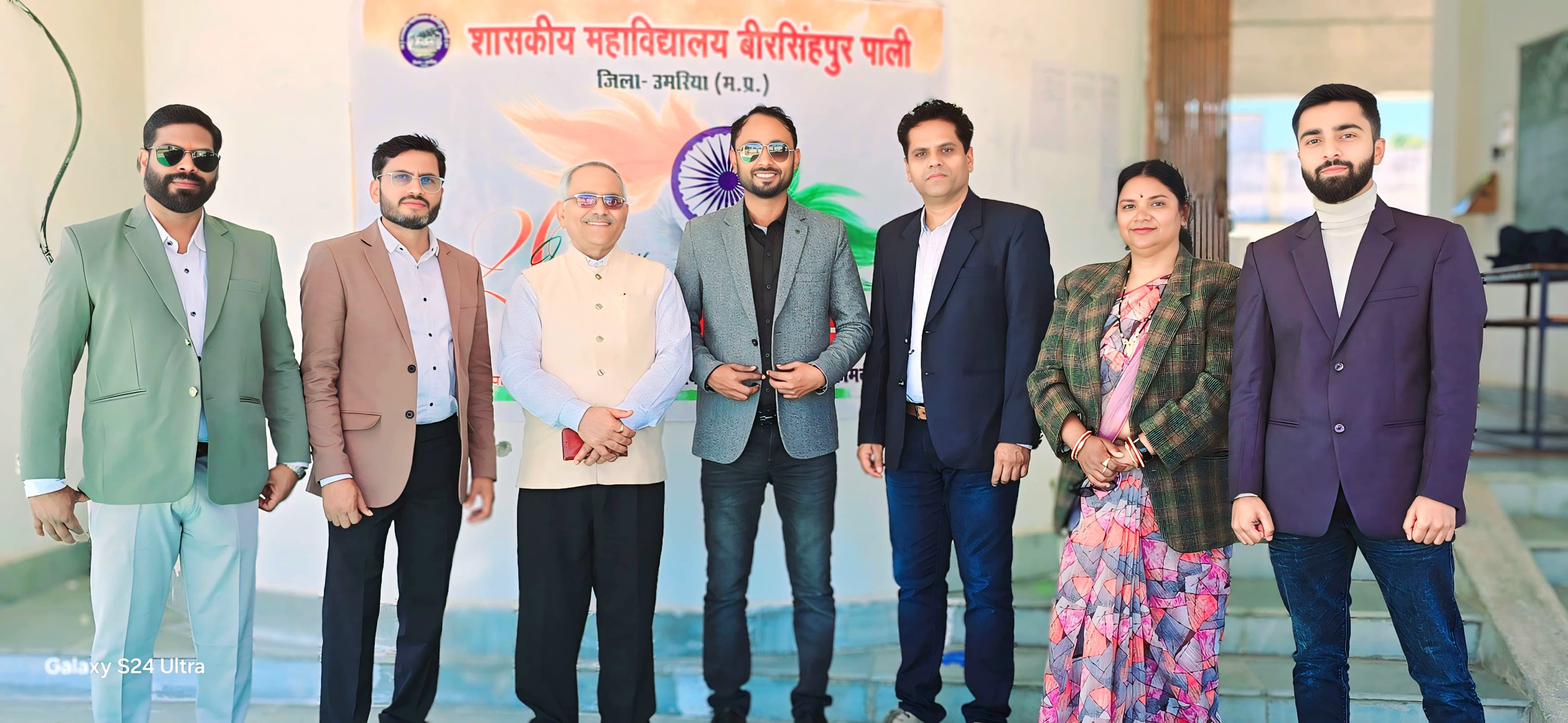 Faculty team group photo with Independence Day banner - Academic staff celebrating national holiday together