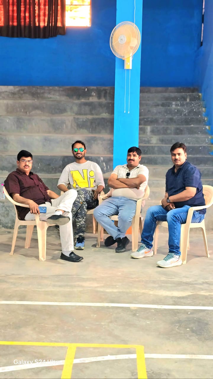 Indoor sports venue during break - Officials and coaches taking break in indoor sports facility bleachers