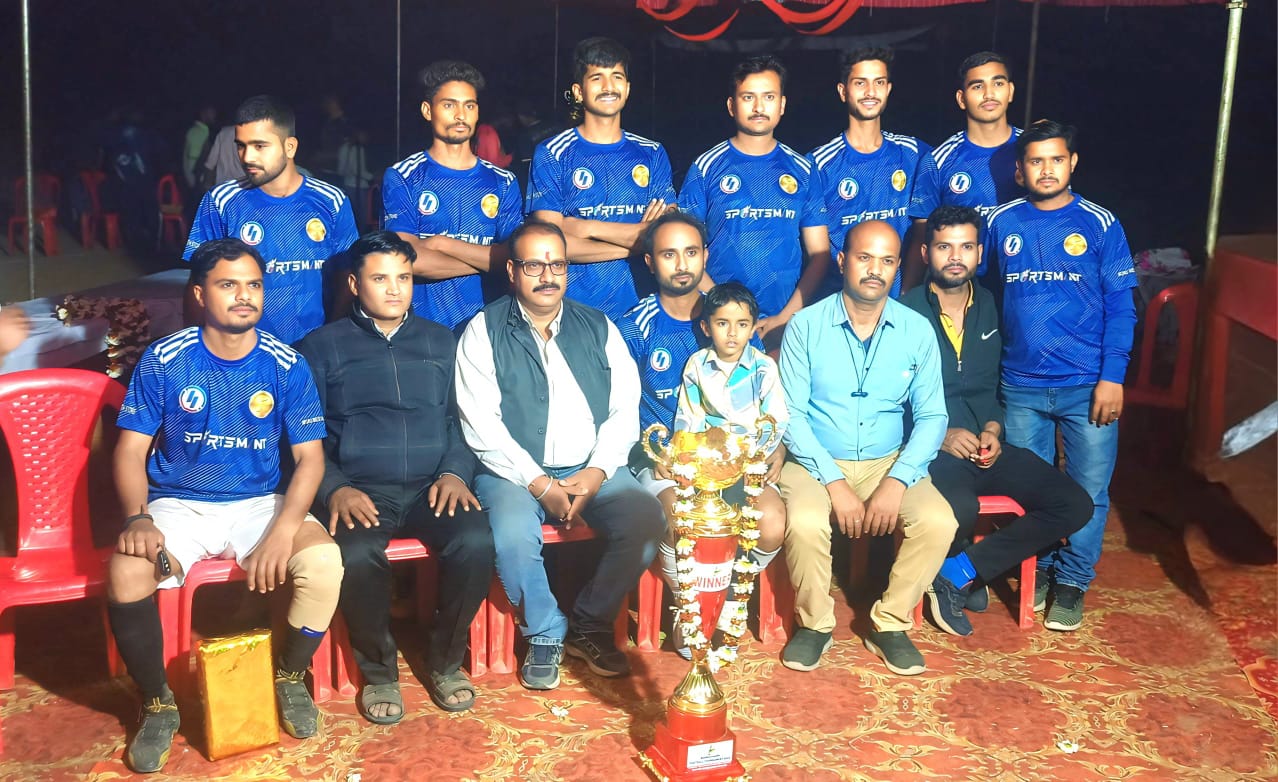 Night football championship celebration - Team celebrating victory under stadium lights with championship trophy