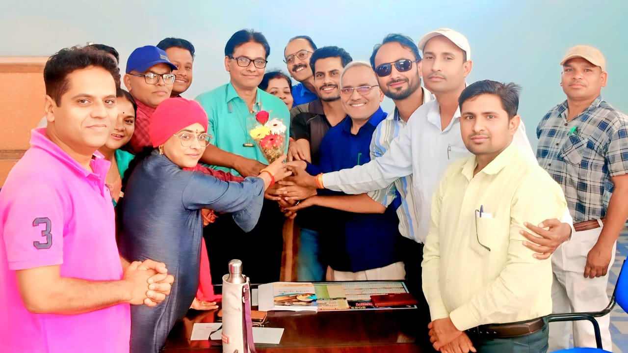 Professional farewell ceremony - Colleague receiving flower bouquet during office farewell celebration