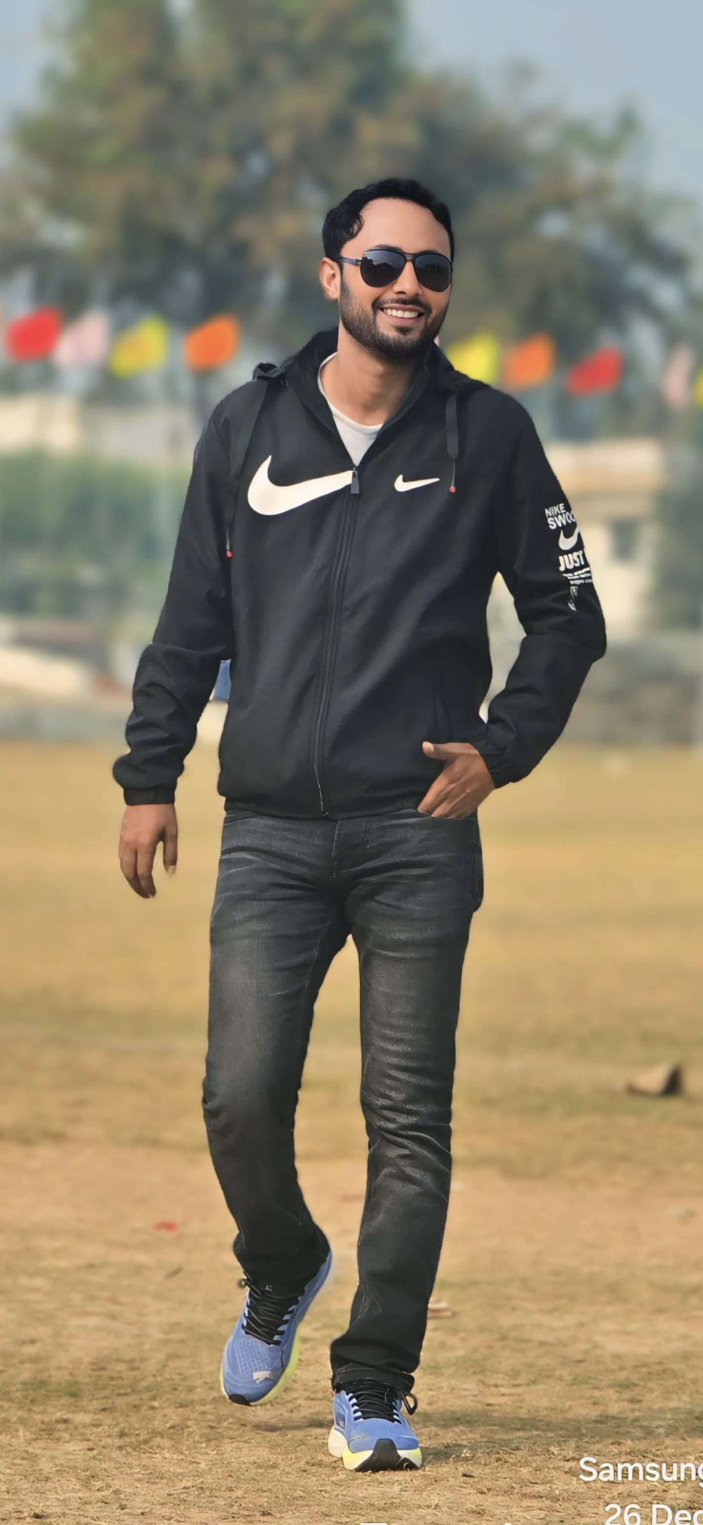 Dr. Shamsher Ali - Professional walking portrait in black Nike hoodie