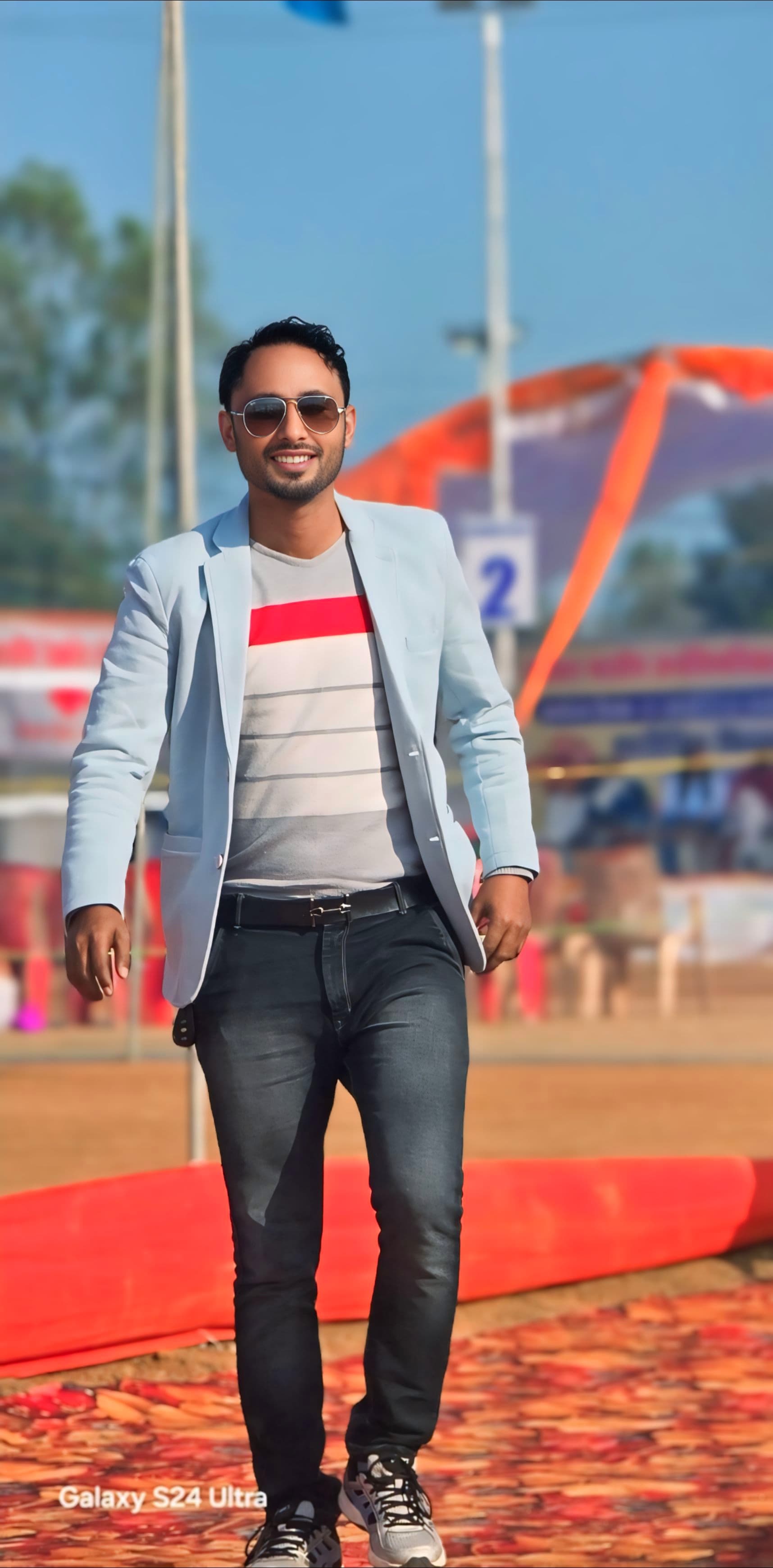 Professional walking portrait in light blue blazer - Confident stride in formal attire during outdoor setting